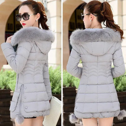 Piumino caldo con cappuccio da donna del nuovo inverno Versione coreana di vestiti imbottiti in cotone slim fit Lungo cappotto di riparazione del corpo di grandi dimensioni Piumino imbottito in cotone da donna Cappotto ispessito per donna